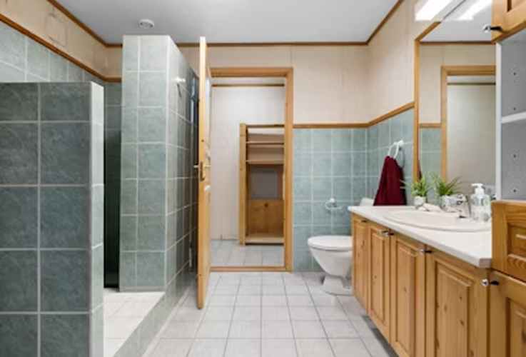 boca Raton bathroom remodel with marble floor tile and frameless shower
